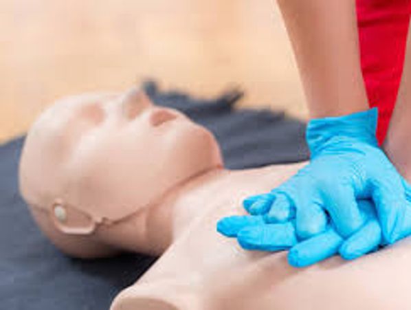 Person performing CPR on a training mannequin.