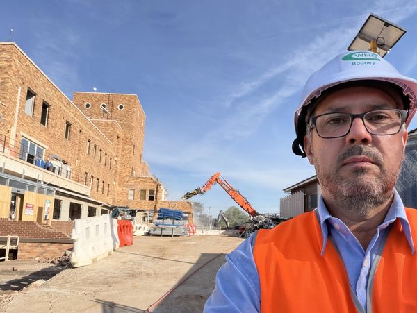 Man in safety gear at construction site.