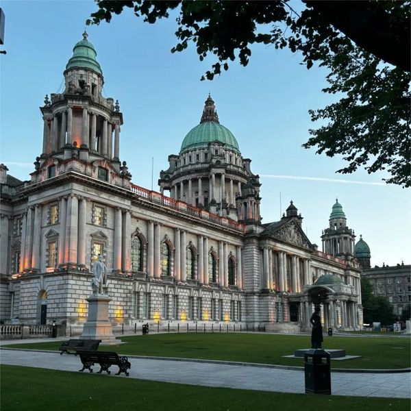 Historic building with domes and columns at dusk.