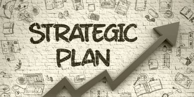 A wall with 'STRATEGIC PLAN' and an upward arrow symbolizing growth.
