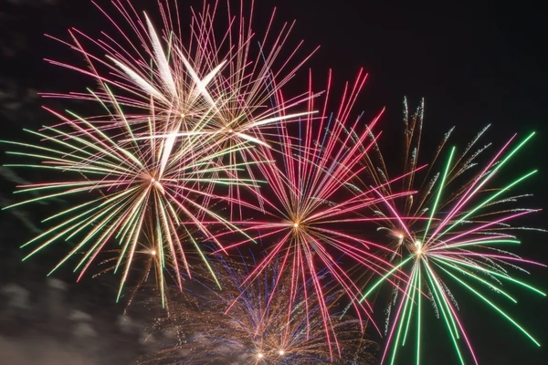 Colorful fireworks exploding in the night sky.
