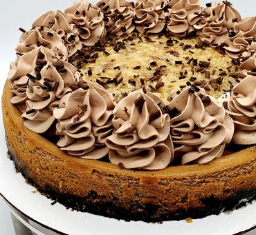 A decedent German chocolate cheesecake topped with coconut and caramel made from scratch.  