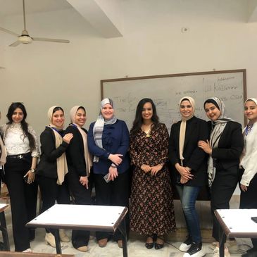 Group of women posing in a classroom.