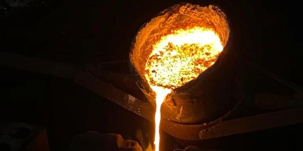 Molten metal such as cast iron,SG Iron, Ductile iron is being poured from the ladle to the mould box
