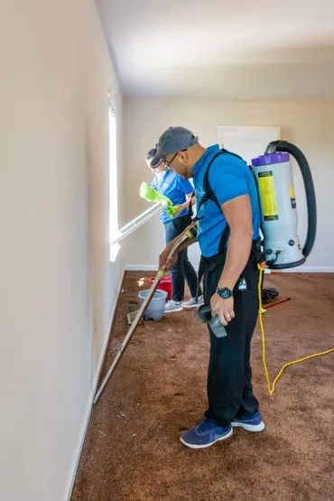 Two people cleaning 