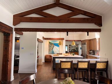 A layered composition of exposed structure and refined finishes, bringing warmth and character to a 