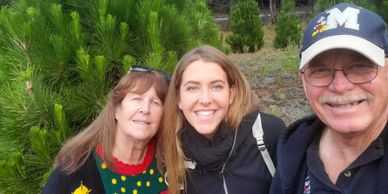 In front of our 12 ft. Christmas tree before cutting it down. She has a 1 m. tree at home in Rome 