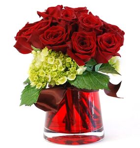 Arrangement of red roses in a red glass vase.