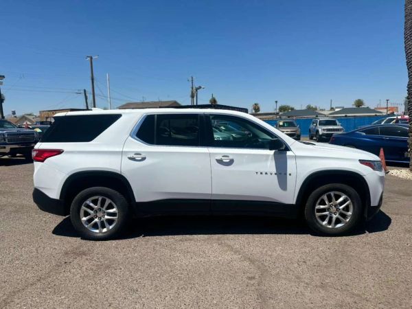 White Chevrolet Traverse SUV parked outdoors on a sunny day.