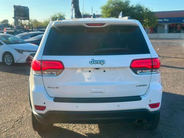 Rear view of a white Jeep Laredo 4x4 SUV.