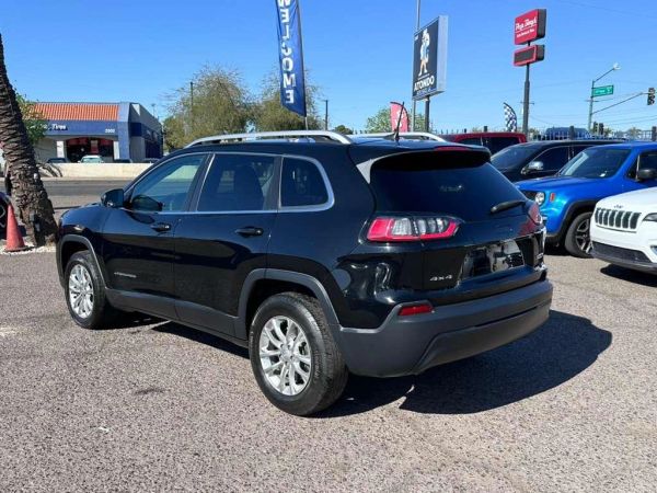 Black Jeep SUV parked on a sunny day.