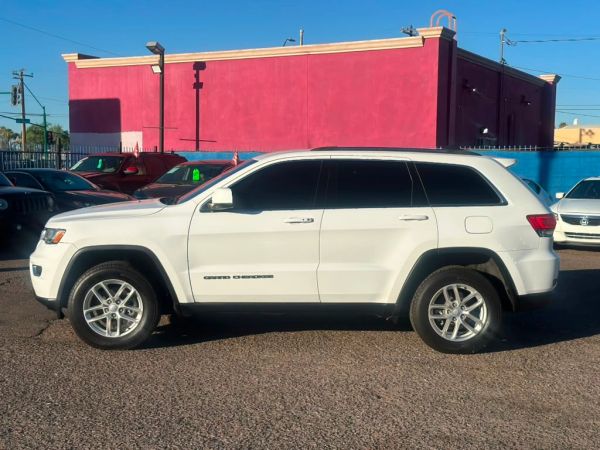 White Jeep Grand Cherokee parked.