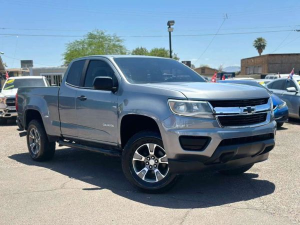 Silver Chevrolet Colorado pickup truck parked outdoors on a sunny day.