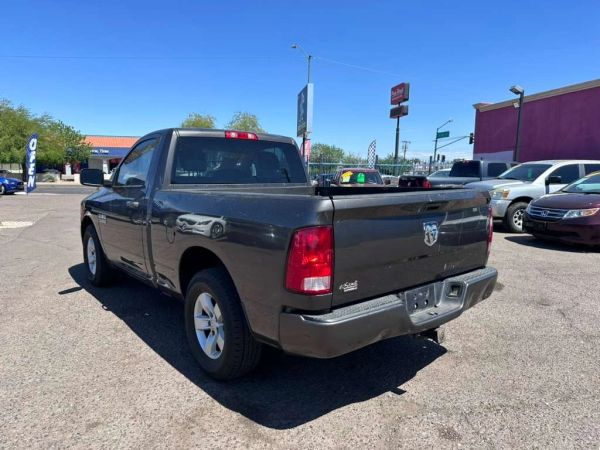 Dark gray Dodge Ram pickup truck parked in a lot on a sunny day.