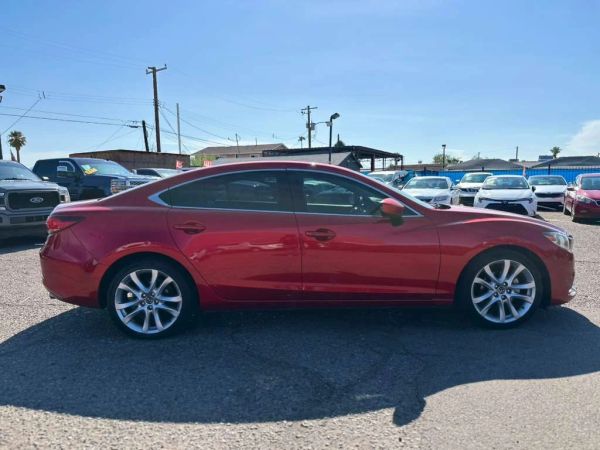 Red sedan car parked outdoors.