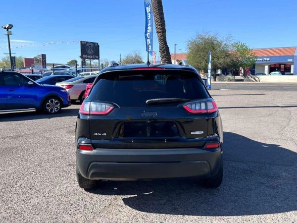 Rear view of a black SUV in a parking lot.