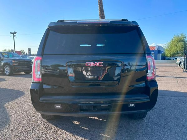 Rear view of a black GMC SUV.