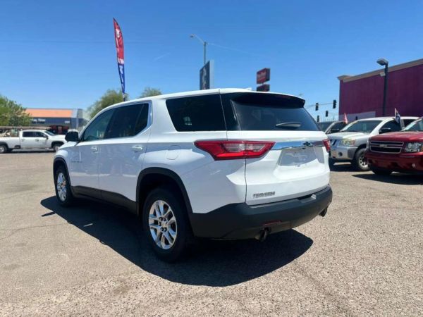 White SUV parked outdoors on a sunny day in a car lot.