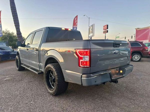 Gray Ford F-150 STX parked in an outdoor lot.
