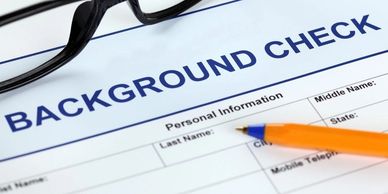 Background check form with pen and glasses.
