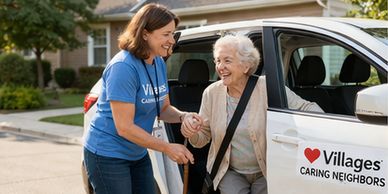 Caregiver helping elderly woman out of a car with a warm smile.