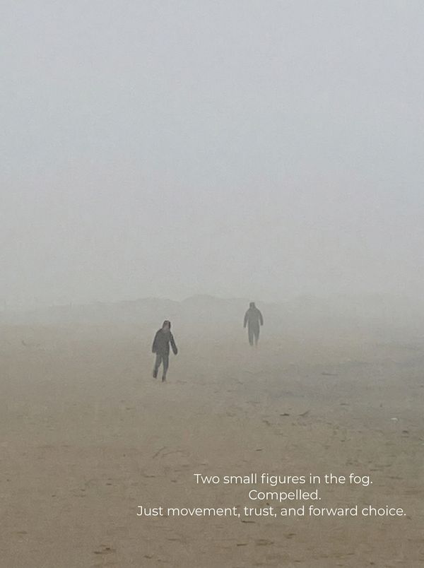 Two small figures walking across sand, calm and purposeful towards a horizon clouded in deep fog.