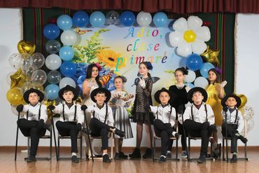 Children dressed up posing for a group photo at a school event.