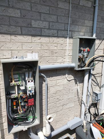 Automatic transfer switch and meterbase for a backup generator installation.