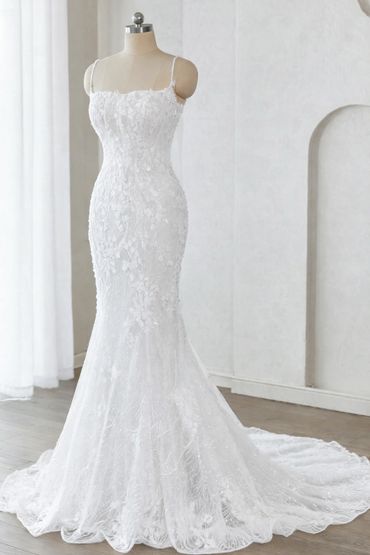 Elegant white lace mermaid wedding dress on a mannequin.