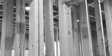 Interior view of wooden framing in a building under construction.