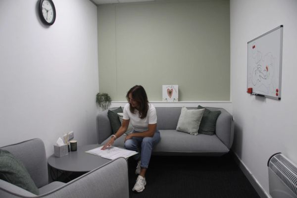 Woman reading in a cozy therapy room.