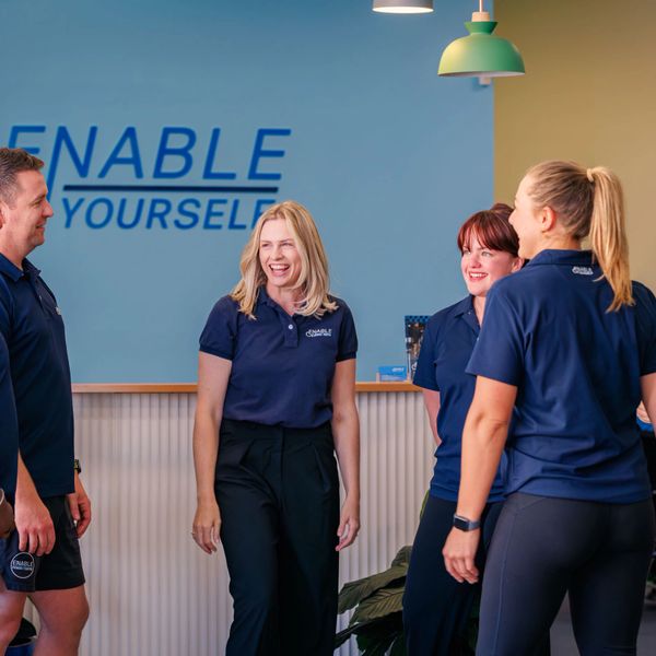 Group of clinicians smiling in accessible gym Adelaide Enable