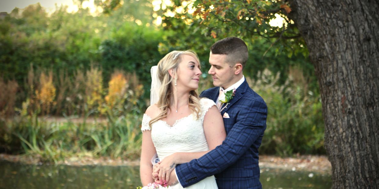 bride and groom next to tree