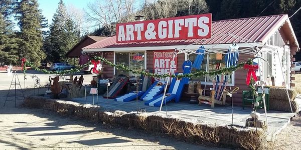 Outdoor art and gifts shop with rustic decorations.