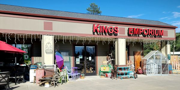 Kings Emporium storefront with outdoor items.