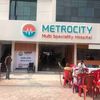 Entrance of Metrocity Multi Speciality Hospital with people outside.