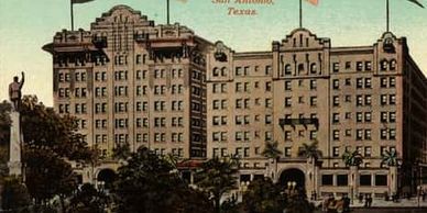 Saint Anthony Hotel rises above Travis Park in downtown San Antonio.