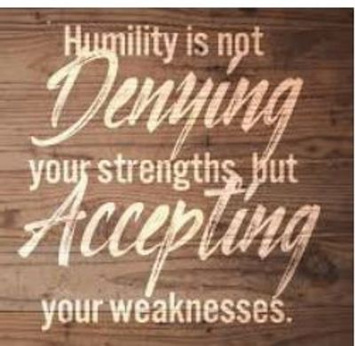 Inspirational quote about humility and acceptance on a wooden background.