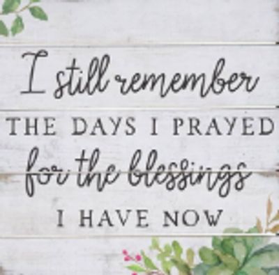 Inspirational quote about gratitude and blessings on a rustic wooden background.