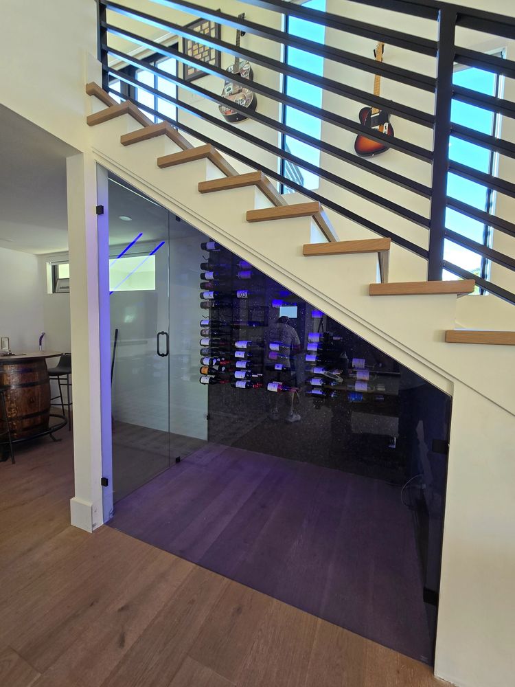 Modern wine cellar under stairs.