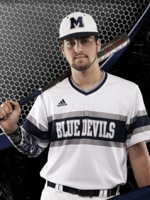 Baseball player in a Blue Devils uniform holding a bat.
