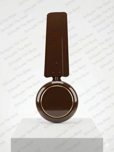 Chocolate sculpture of a frying pan with a handle on a pedestal.