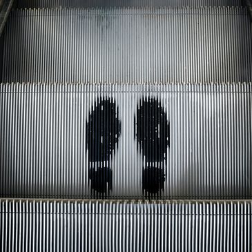 A photo of a person's footprint on an escalator.