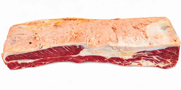 Raw beef brisket with fat cap on a white background.