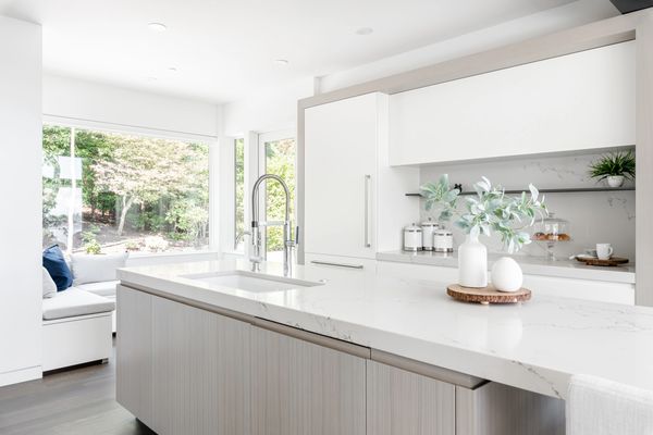 interior design renovated modern kitchen  with white quartz island  open shelving built in seating 