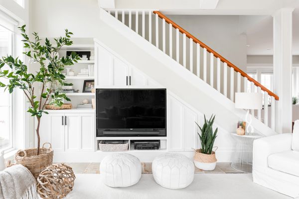 interior design built in TV storage unit in living room with shelving and white cabinetry 