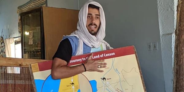 A man standing and holding a box