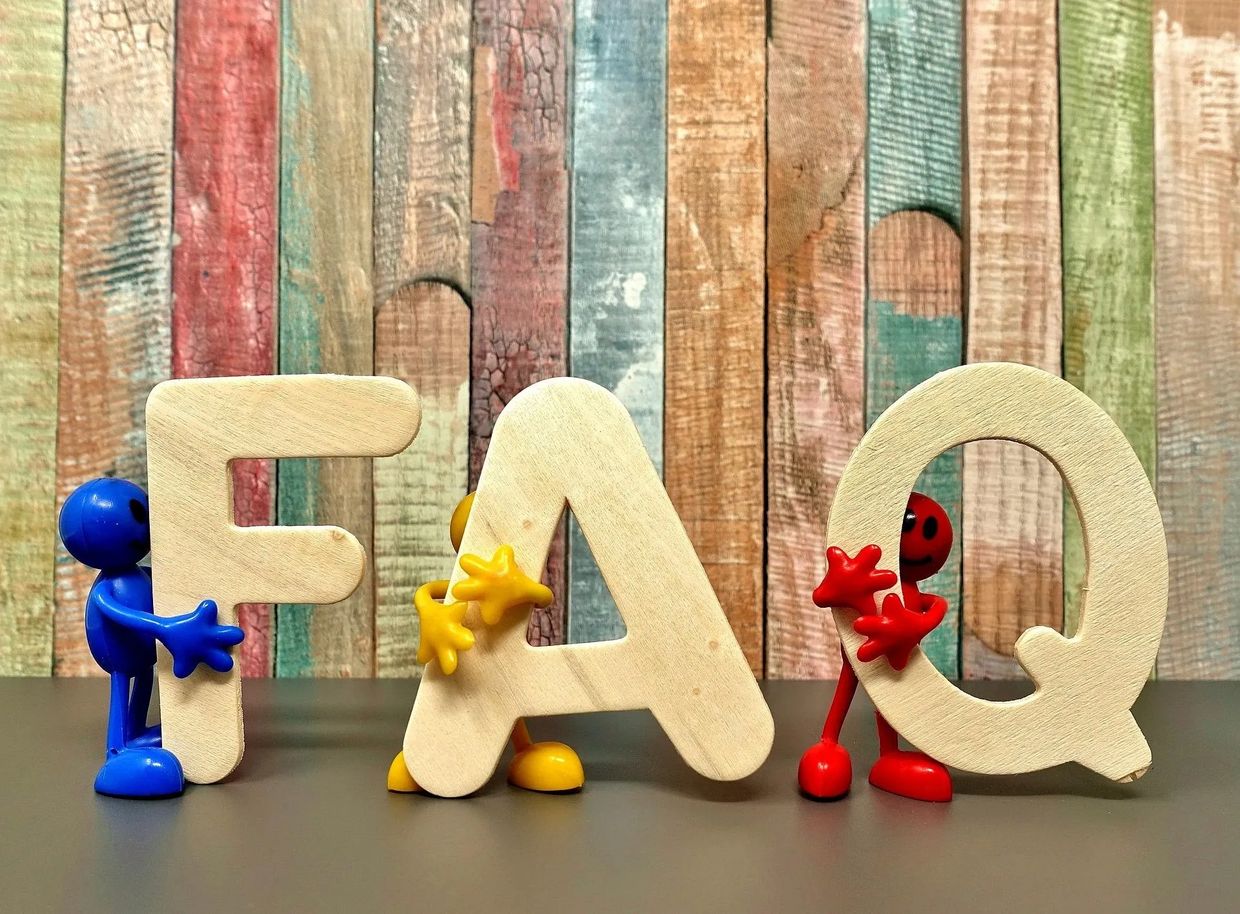 Frequently asked questions stock photo of wooden letters and figures in primary colors.