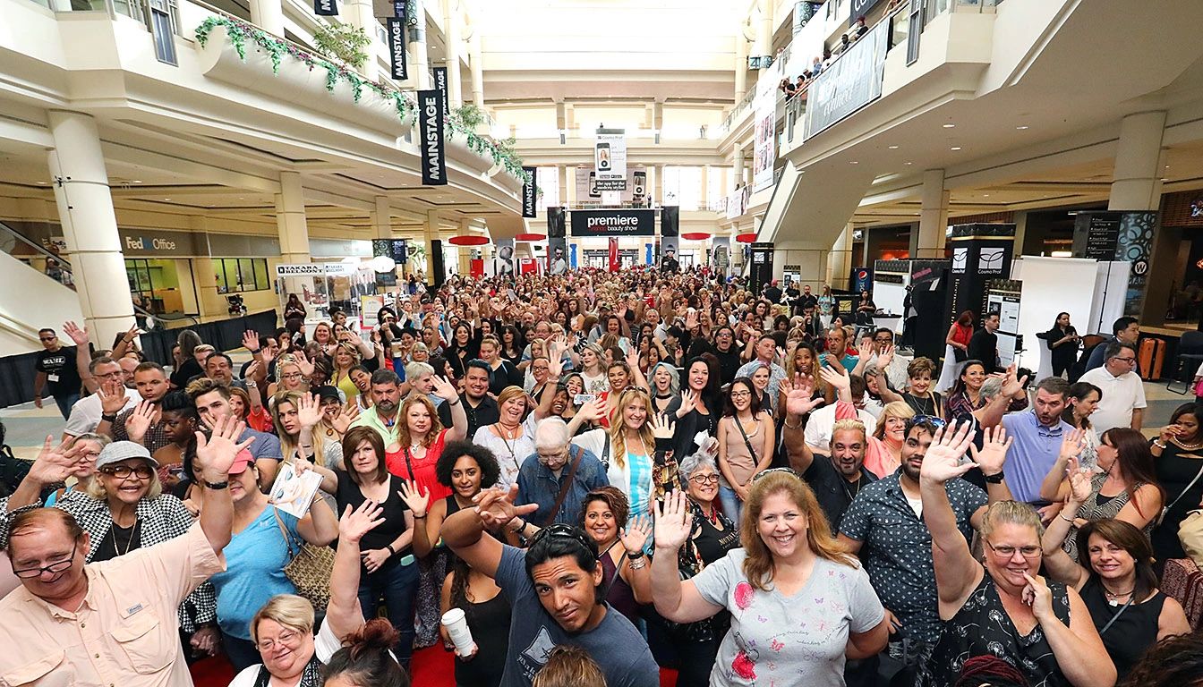 Huge group photo of enthusiastic conference attendees waiting to enter the expo hall.
