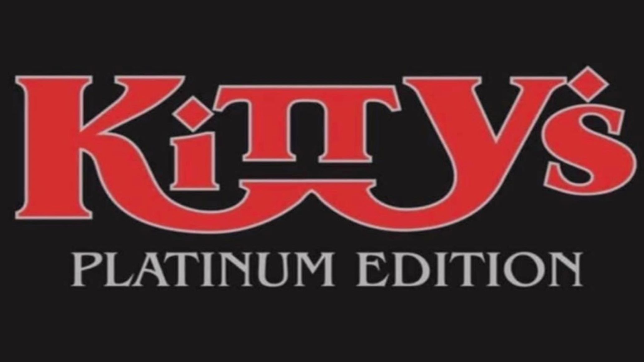 Close-up of a grand piano with its lid open in a concert hall.